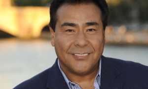 John Quiñones, Emmy Award-winning ABC News journalist and host of What Would You Do?, smiling in a professional portrait.